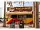 Pop Dawgs restaurant offering outdoor seating and shade under sunny skies at 13829 Alafaya St, Venice, FL 34293
