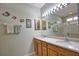 Bathroom featuring a double vanity, large mirror and shower with glass door at 1438 Maseno Dr, Venice, FL 34292