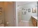 Bathroom featuring a single vanity, framed mirror and a shower with glass door at 1438 Maseno Dr, Venice, FL 34292