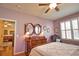 Bedroom showcasing a large dresser with oval mirrors and plantation shutters at 1438 Maseno Dr, Venice, FL 34292