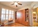 Light-filled bedroom featuring a built-in wardrobe and plantation shutters at 1438 Maseno Dr, Venice, FL 34292