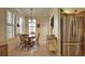 Charming dining area bathed in natural light, complete with stainless steel refrigerator at 1438 Maseno Dr, Venice, FL 34292