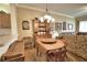 Charming dining area with hardwood floors, a vintage hutch, and plenty of natural light at 1438 Maseno Dr, Venice, FL 34292