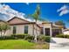 Charming home exterior with beautiful landscaping, a well-manicured lawn, and a welcoming entrance at 1438 Maseno Dr, Venice, FL 34292