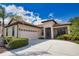 Charming single-story home featuring a terracotta roof, two-car garage and lush landscaping at 1438 Maseno Dr, Venice, FL 34292