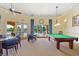Game room with pool table and card tables with access to the outdoor pool at 1438 Maseno Dr, Venice, FL 34292
