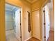 Hallway view showcasing access to the bathroom and bedrooms at 1438 Maseno Dr, Venice, FL 34292