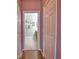 Hallway with hardwood floors leading to a bathroom at 1438 Maseno Dr, Venice, FL 34292