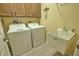Laundry room with washer, dryer, utility sink and cabinets at 1438 Maseno Dr, Venice, FL 34292