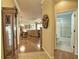 Open-concept living area with hardwood floors, decorative accents, and access to the bathroom at 1438 Maseno Dr, Venice, FL 34292
