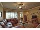 Inviting living room featuring a leather sectional sofa and sliding glass doors to the outdoor space at 1438 Maseno Dr, Venice, FL 34292