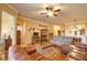 Spacious living room with hardwood floors, ceiling fan, and access to other rooms at 1438 Maseno Dr, Venice, FL 34292