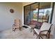 Relaxing patio features a seating area with comfortable chairs and a small table at 1438 Maseno Dr, Venice, FL 34292