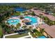 A stunning aerial view of a community pool, jacuzzi, and surrounding palm trees at 1438 Maseno Dr, Venice, FL 34292