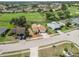 Wide aerial view of the house in its neighborhood, showcasing the street, golf course, and the nearby community at 1439 Strada D Argento, Venice, FL 34292