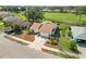 Aerial view of the property, showcasing the roof, driveway, landscaping, and surrounding neighborhood at 1439 Strada D Argento, Venice, FL 34292