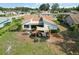 Aerial view showcases home's backyard patio with awning and exterior, with a view of the surrounding neighborhood at 1439 Strada D Argento, Venice, FL 34292