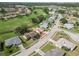 Stunning aerial view of homes in a golf community with lush green fairways and serene water features at 1439 Strada D Argento, Venice, FL 34292