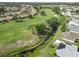 Aerial view of a home near a golf course and canal in a lush residential community at 1439 Strada D Argento, Venice, FL 34292