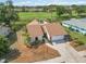 Aerial view of the house showcasing roof, driveway, and landscaping in a well-maintained neighborhood at 1439 Strada D Argento, Venice, FL 34292