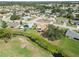 Aerial view showcases a home with a backyard, patio, and nearby stream in a residential neighborhood at 1439 Strada D Argento, Venice, FL 34292