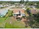 Aerial view of a home's backyard featuring a patio area with comfortable seating under a stylish sunshade at 1439 Strada D Argento, Venice, FL 34292