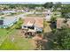 Aerial view of a home's backyard featuring a patio area with comfortable seating under a stylish sunshade at 1439 Strada D Argento, Venice, FL 34292