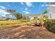 Backyard view with a patio seating area under a canopy with views of the lawn and green golf course at 1439 Strada D Argento, Venice, FL 34292