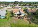 Aerial view of a home's backyard featuring a patio area with comfortable seating under a stylish sunshade at 1439 Strada D Argento, Venice, FL 34292