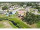 Aerial view showcases a home with a backyard, patio, and nearby stream in a residential neighborhood at 1439 Strada D Argento, Venice, FL 34292