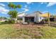 Spacious backyard featuring a canopy over the patio area, a screened lanai and mature landscaping at 1439 Strada D Argento, Venice, FL 34292