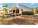 Outdoor patio area with canopy covering a seating arrangement, perfect for relaxation and outdoor enjoyment at 1439 Strada D Argento, Venice, FL 34292