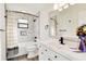 Updated bathroom featuring modern fixtures, marble tile, and a shower-tub combo at 1439 Strada D Argento, Venice, FL 34292