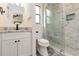 Bright bathroom with marble shower, granite countertop, and modern fixtures at 1439 Strada D Argento, Venice, FL 34292