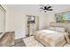 Bright bedroom with a ceiling fan, natural light, and charming wood-look furniture at 1439 Strada D Argento, Venice, FL 34292