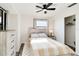 Bright bedroom featuring a ceiling fan, natural light, and wood-look furniture at 1439 Strada D Argento, Venice, FL 34292