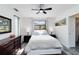 Comfortable bedroom with a ceiling fan and plenty of natural light from the window at 1439 Strada D Argento, Venice, FL 34292