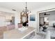 Open dining area with chandelier, flows into a view of a bedroom and living room at 1439 Strada D Argento, Venice, FL 34292