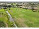 Scenic aerial view of a lush golf course with manicured greens and tree-lined fairways, offering a picturesque setting at 1439 Strada D Argento, Venice, FL 34292