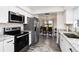 Charming kitchen features stainless appliances, marbled countertops, and wood-look flooring at 1439 Strada D Argento, Venice, FL 34292