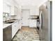 Modern kitchen featuring stainless steel appliances, granite countertops, and stylish cabinetry at 1439 Strada D Argento, Venice, FL 34292