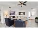 Cozy living room featuring neutral sofa, comfortable seating, and sleek entertainment setup with a large TV at 1439 Strada D Argento, Venice, FL 34292