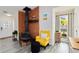 Cozy living room showcasing a unique fireplace and bright yellow accent chair at 1439 Strada D Argento, Venice, FL 34292