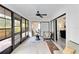 Sunroom features ceiling fan, tile flooring, and a view into several rooms of the house at 1439 Strada D Argento, Venice, FL 34292