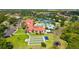 Aerial view of community pools, tennis courts, lawn games, clubhouse and a pond at 1481 Hyssop Loop, North Port, FL 34289
