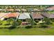 Aerial view of home with fenced-in backyard, screened-in patio, and mature landscaping at 1481 Hyssop Loop, North Port, FL 34289