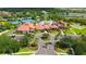 Aerial view of clubhouse, pool, tennis courts, garden, and entrance to the community at 1481 Hyssop Loop, North Port, FL 34289