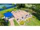Aerial view of covered patio with tables and chairs in a landscaped community amenity area at 1481 Hyssop Loop, North Port, FL 34289