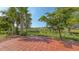 Paver patio with mature landscaping and views of the pond at 1481 Hyssop Loop, North Port, FL 34289