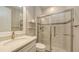 Bathroom featuring granite vanity and glass shower at 1481 Hyssop Loop, North Port, FL 34289
